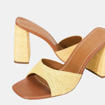 Sloane Heel tan woven raffia slide sandals with brown leather insoles and thick, matching block heels in a timeless silhouette.