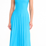 A woman wears a cobalt Ellison Dress, a sleeveless midi with a square neckline and a pleated skirt for a flattering fit.