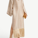 KABE SHOP INC Tigris ecru linen-blend gown with wide sleeves and dramatic fringe hem worn by a model