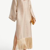 KABE SHOP INC Tigris ecru linen-blend gown with wide sleeves and dramatic fringe hem worn by a model