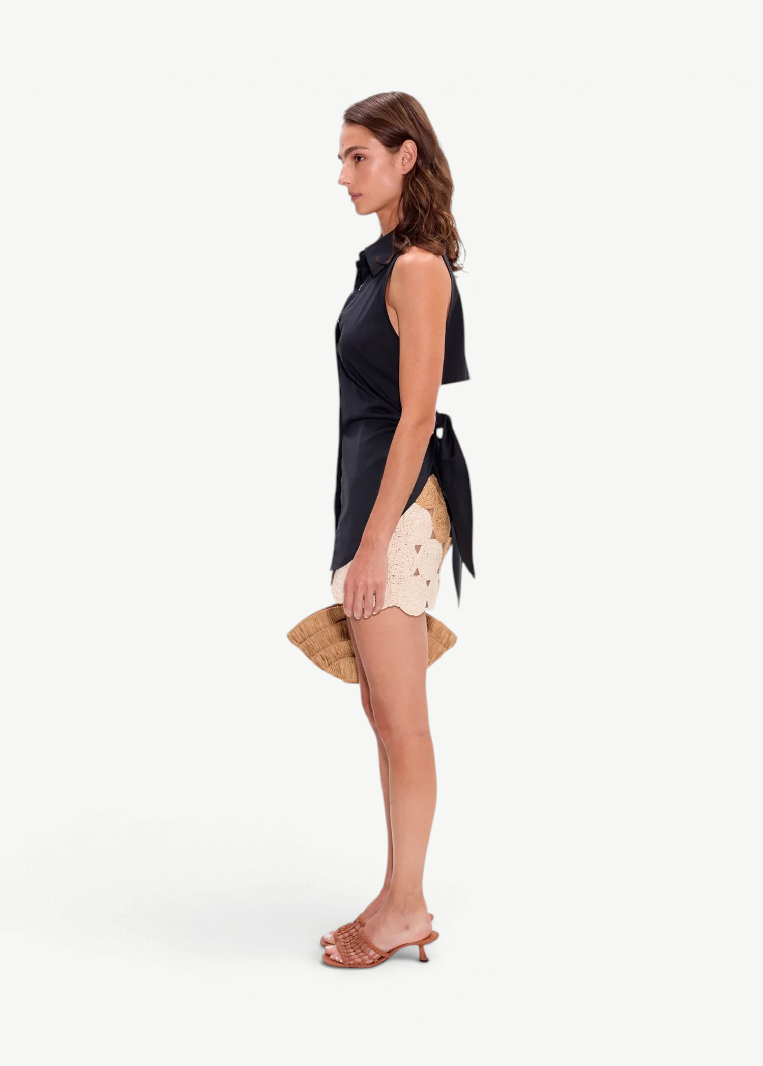 KABE SHOP INC Beep Beep mini skirt in earth-tone crochet with circular motifs, worn with a black sleeveless top.