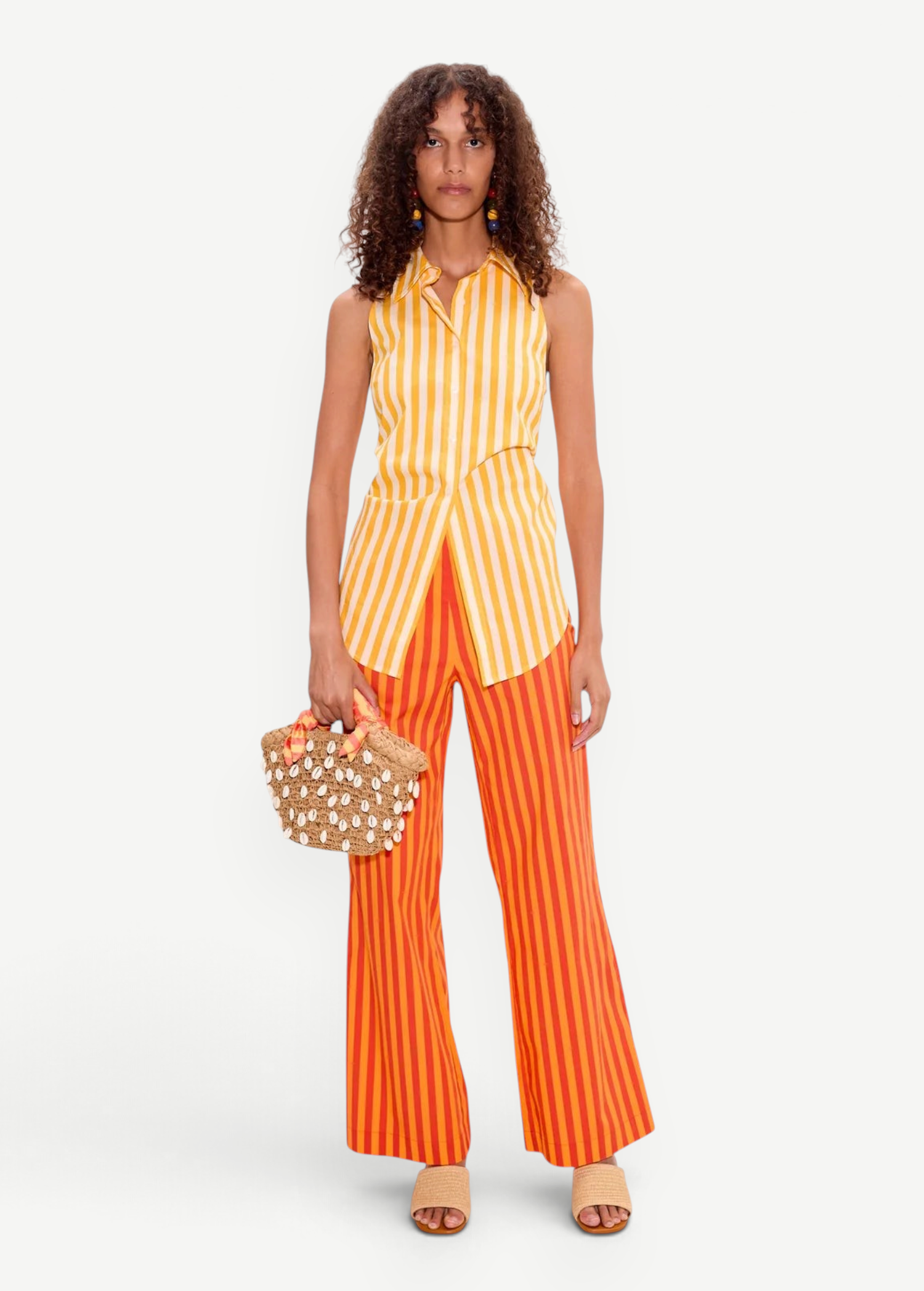 KABE SHOP INC Loch sleeveless yellow and white striped cotton poplin button-up shirt worn with orange striped pants.