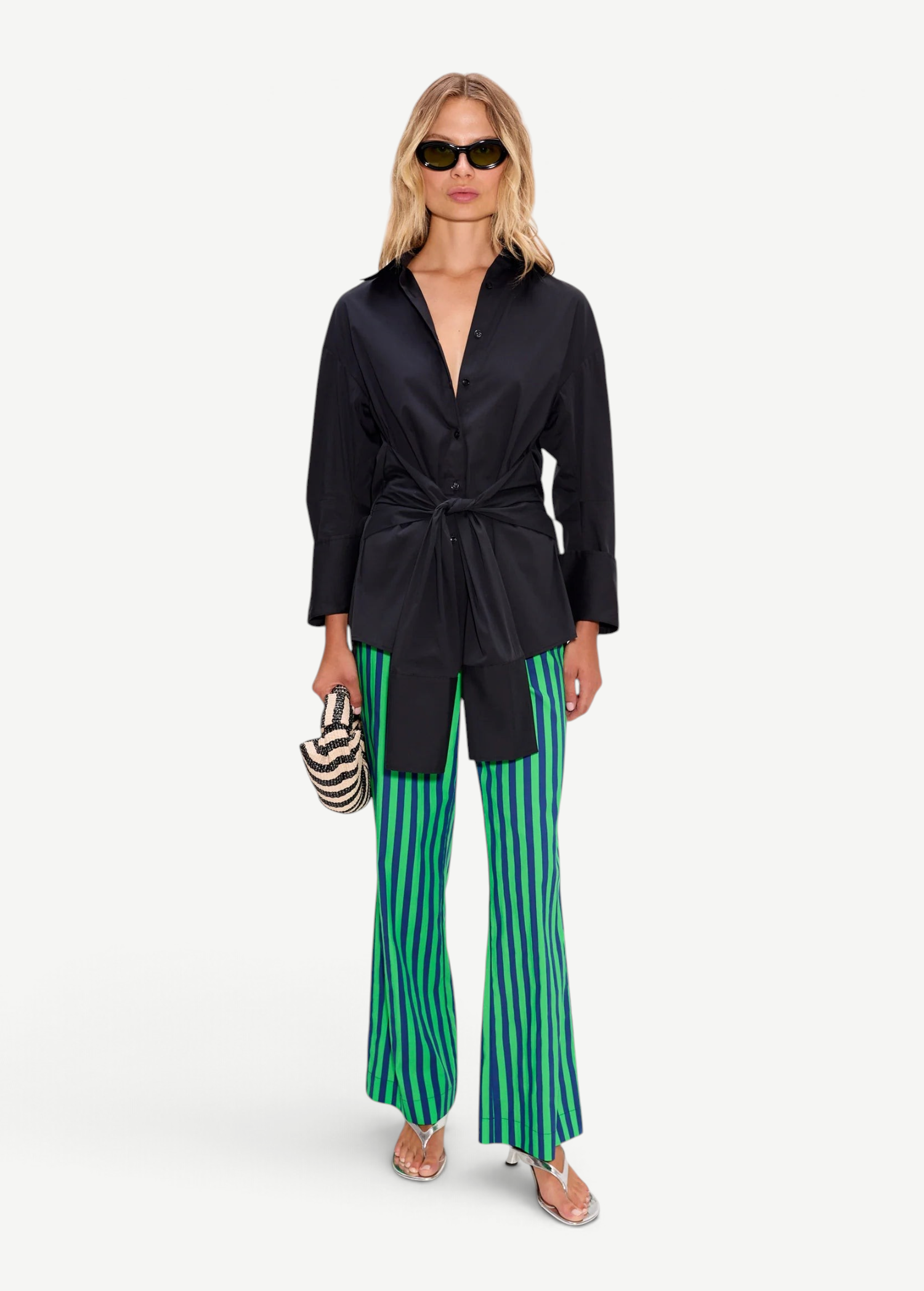 Model wearing KABE SHOP INC Pia Poplin Pant in vibrant green and blue stripes with a black button-down shirt