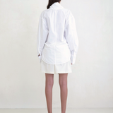 Back view of a model wearing the white KABE SHOP INC Leandra wrap shirt with a relaxed fit and long sleeves.