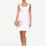 KABE SHOP INC Wells mini dress in white with blue floral embroidery, featuring a square neckline and flared skirt.