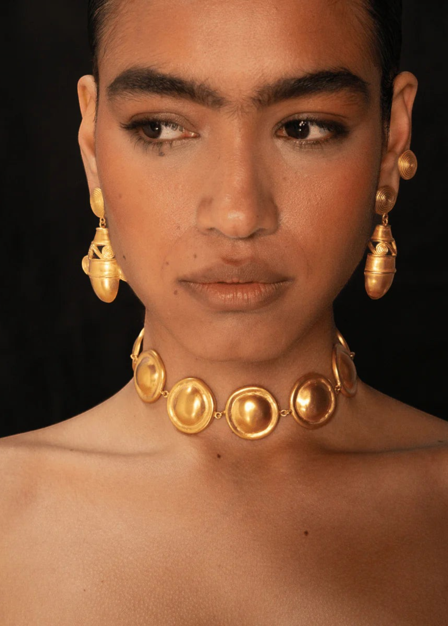 KABE SHOP INC Wasi choker featuring sculptural golden spheres inspired by Tayrona culture worn by a model