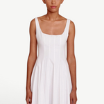 Model wearing a KABE SHOP INC white Wells dress with a square neckline and fitted bodice on a neutral background.