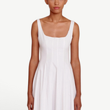 Model wearing a KABE SHOP INC white Wells dress with a square neckline and fitted bodice on a neutral background.