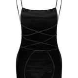 Black sleeveless Xena Top with thin shoulder straps and a minimalist, crisscross lace-up design at the waist.