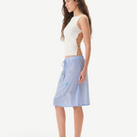KABE SHOP INC Zelna top in white with sculptural stud details and open-back design worn by a model in profile