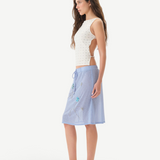 KABE SHOP INC Zelna top in white with sculptural stud details and open-back design worn by a model in profile