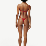 Model wearing a KABE SHOP INC red bikini set with thin straps and a minimalist thong bottom, back view.