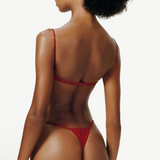 KABE SHOP INC red balconette bikini top with thin straps worn by a model, back view showing minimalist design.