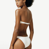 Model wearing KABE SHOP INC white Classic Bottom bikini swimwear with a versatile high or low hip silhouette