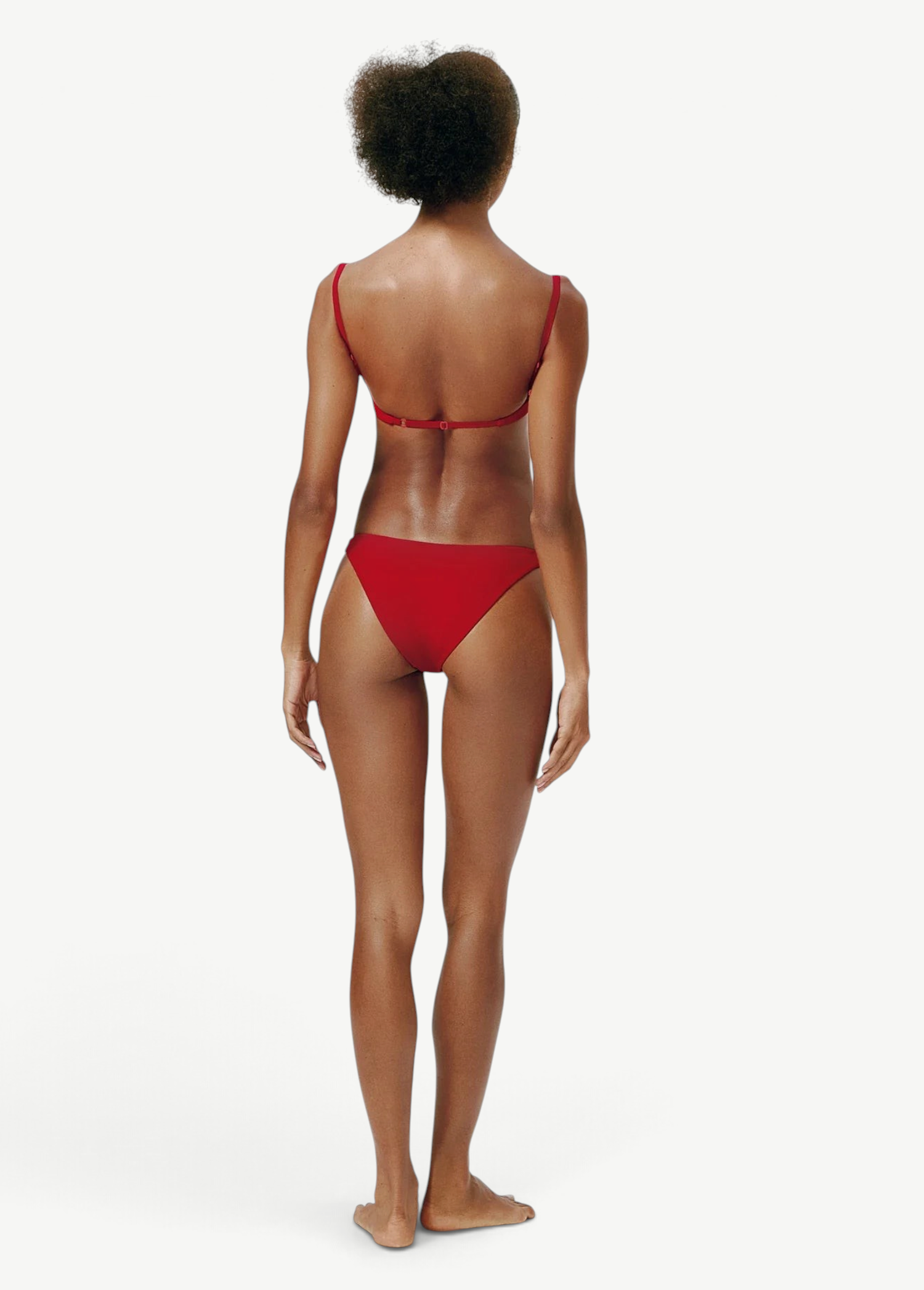 Model wearing KABE SHOP INC Classic Bottom in red, featuring a flattering medium-stretch recycled fabric design.