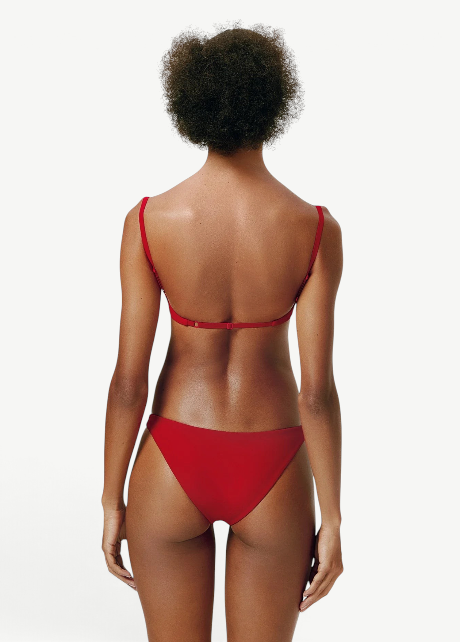 Model wearing KABE SHOP INC Classic Bottom in red, featuring a flattering medium-stretch recycled fabric fit.