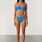 Model wearing KABE SHOP INC ocean blue textured bikini set with high-cut brief and curved waistline