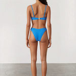 KABE SHOP INC ocean blue textured bikini brief with high-cut leg and curved waistline worn by a model from behind