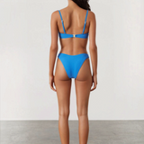 KABE SHOP INC ocean blue textured bikini brief with high-cut leg and curved waistline worn by a model from behind