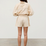 KABE SHOP INC Shea Hemp Blend cream shorts with elastic waistband and white piping, back view on a model.