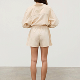 KABE SHOP INC Shea Hemp Blend cream shorts with elastic waistband and white piping, back view on a model.