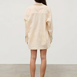 KABE SHOP INC cream hemp blend shirt with white floral embroidery on the back worn by a woman