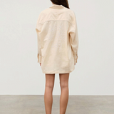 KABE SHOP INC cream hemp blend shirt with white floral embroidery on the back worn by a woman