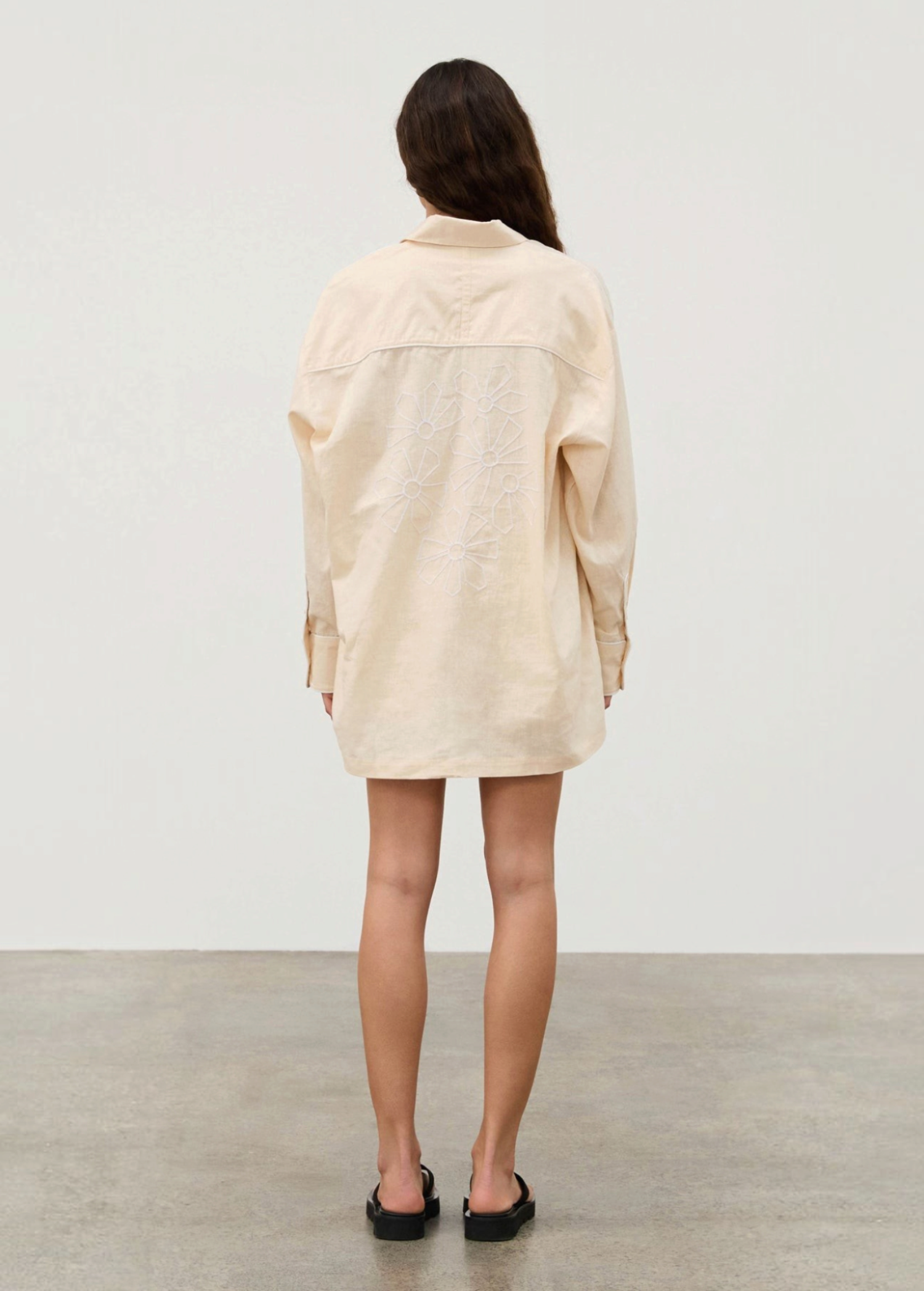 KABE SHOP INC cream hemp blend shirt with white floral embroidery on the back worn by a woman