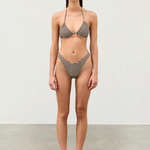 Model wearing KABE SHOP INC Cocoa Grid halter bikini top and matching high-cut bottoms with a brown grid pattern.