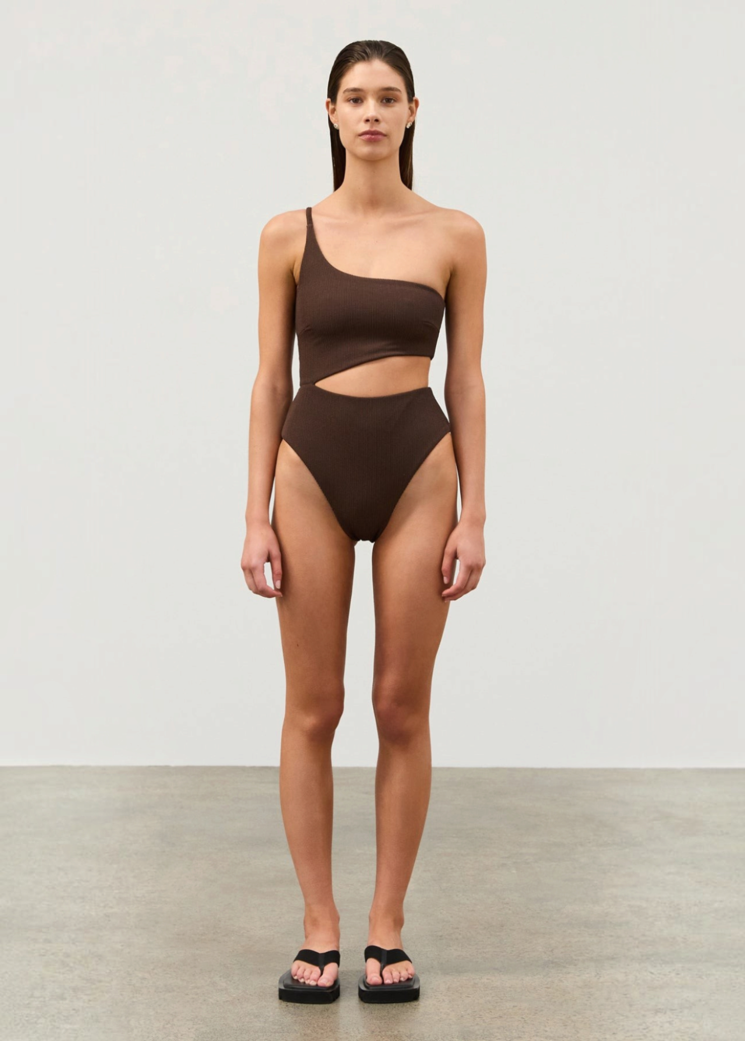KABE SHOP INC Cocoa Textured One Piece with a one-shoulder design, waist cut-out, and ribbed fabric in dark brown.