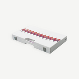 The ZigZag Backgammon Board Game features a closed white acrylic case adorned with colorful zigzag patterns and metal clasps, as well as a small handle slot centered at the front—making this striking set a standout on any coffee table.