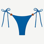 Praia Bottom in blue, crafted from eco-friendly Peach Perfect fabric, features adjustable side tie strings with brown bead accents on each hip. Displayed on a white background, this swimwear combines comfort and style for a flawless fit.