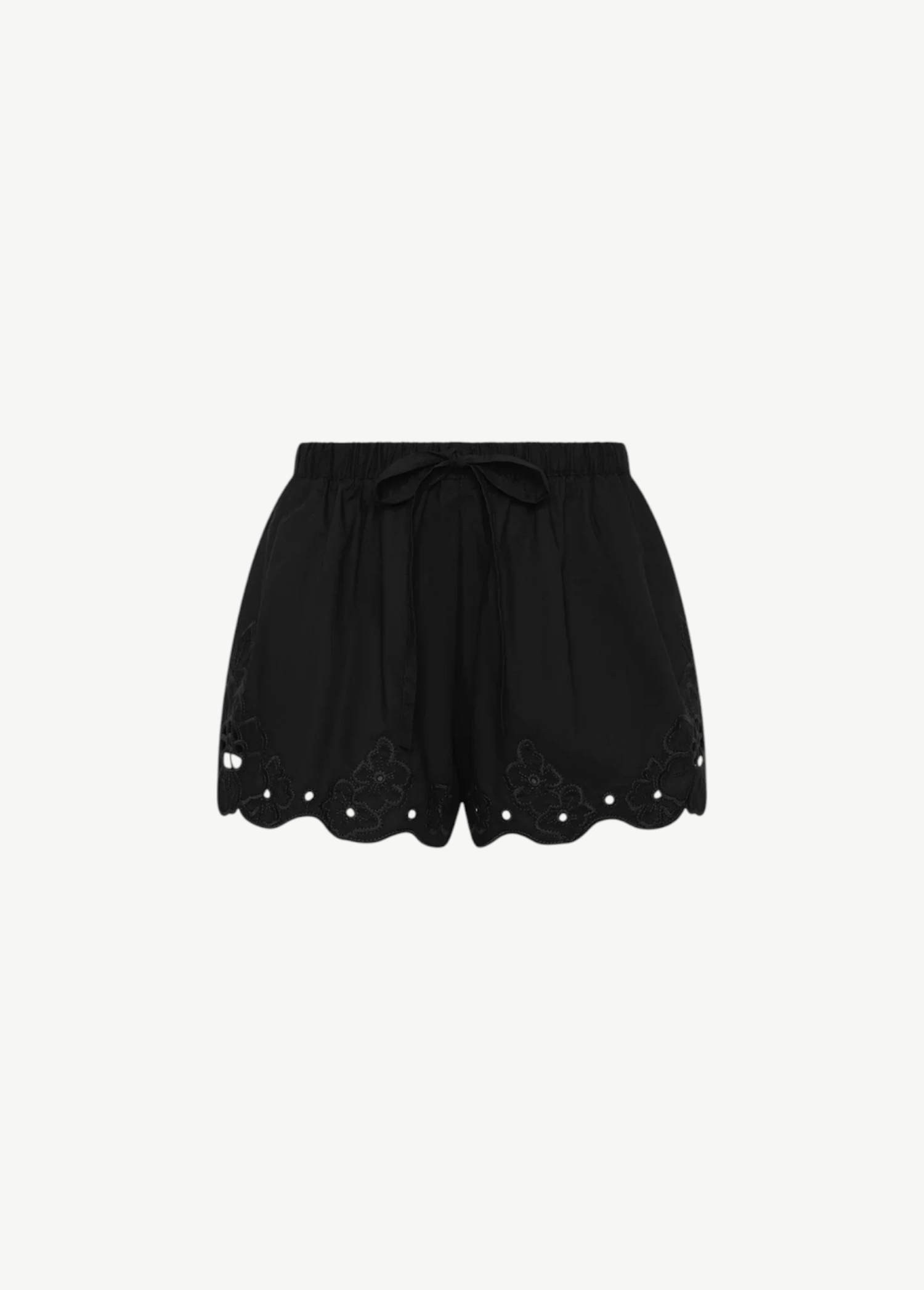 Klara Mini Short in black, featuring a pull-on design, tie waistband, and a scalloped hem with floral cut-out embroidery.