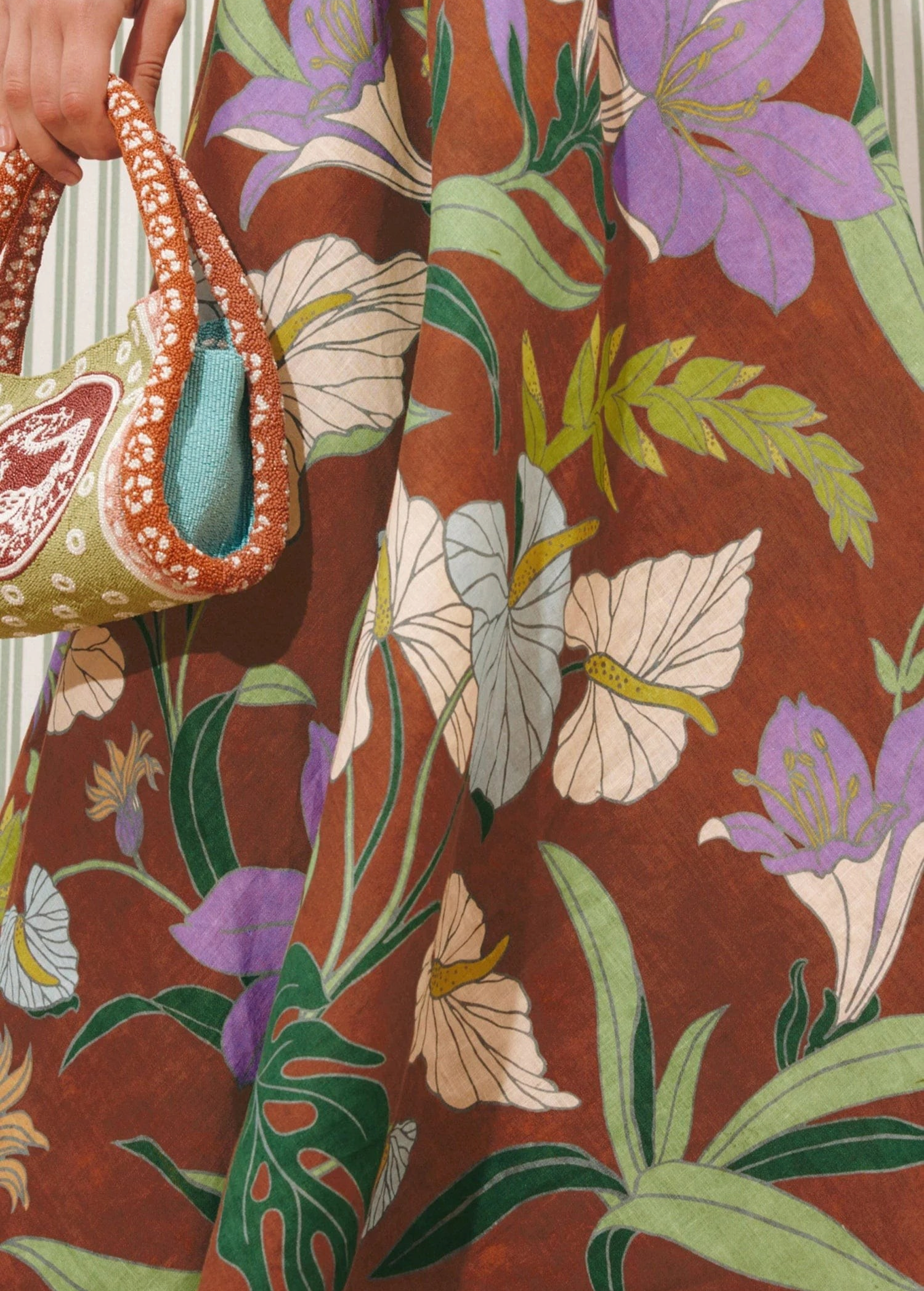 KABE SHOP INC Alfie Twist Sundress featuring a brown midi dress with a vibrant purple and green floral botanical print.