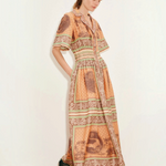 Model wearing KABE SHOP INC Alberta midi shirtdress in orange with tropical print, cinched waist, and collar detail.