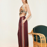 Model wearing KABE SHOP INC Wilson relaxed jogger pants in deep burgundy with side stripe and geometric hem detail