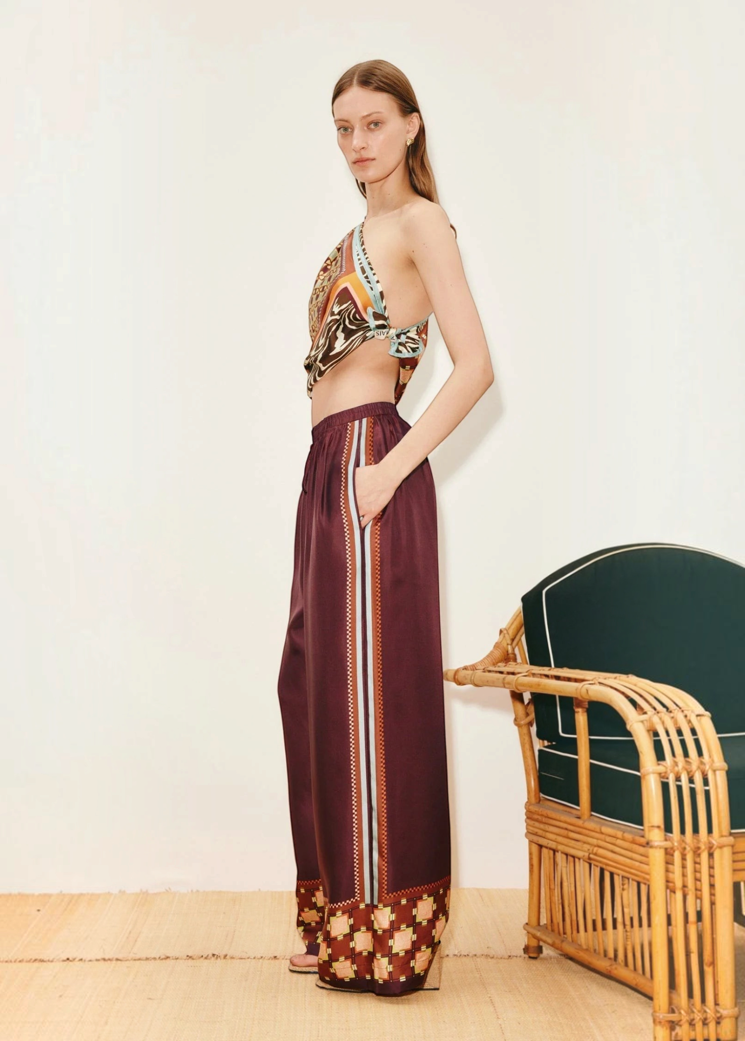 Model wearing KABE SHOP INC Wilson relaxed jogger pants in deep burgundy with side stripe and geometric hem detail