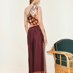 KABE SHOP INC Wilson pants in deep burgundy with a patterned hem, worn by a model in a relaxed, wide-leg silhouette.