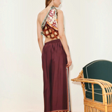 KABE SHOP INC Wilson pants in deep burgundy with a patterned hem, worn by a model in a relaxed, wide-leg silhouette.