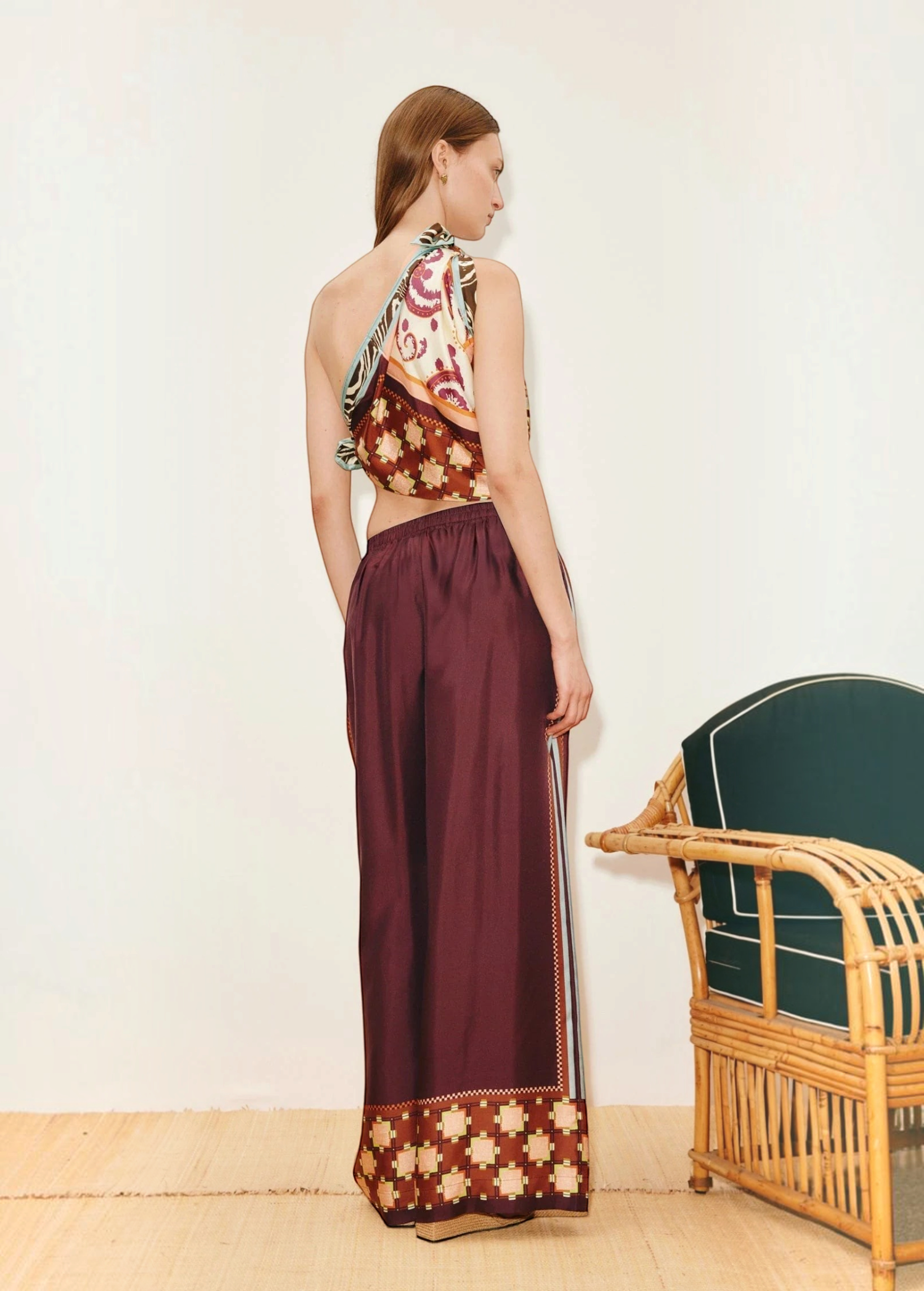 KABE SHOP INC Wilson pants in deep burgundy with a patterned hem, worn by a model in a relaxed, wide-leg silhouette.