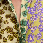 The Patty Shirt features an artistic, color-blocked floral print in shades of lime green, brown, teal, and purple.