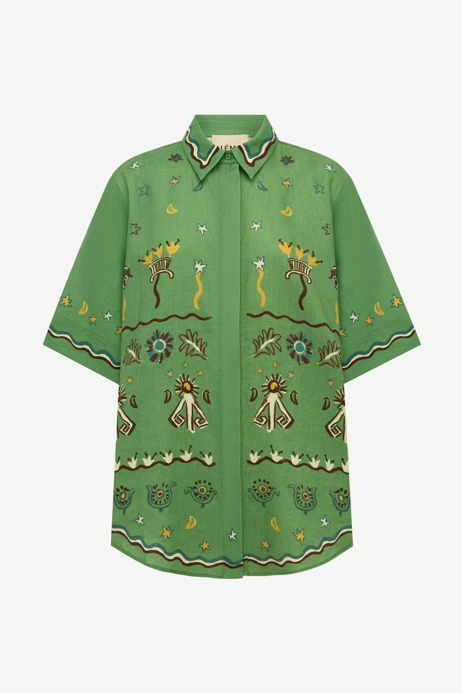 The green, relaxed fit Sun Dancer Shirt features a button-up front and an embroidered pattern of stars, moons, and abstract floral motifs.