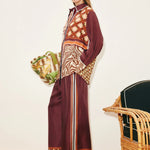 A person wears a Wilson Shirt and matching wide-leg trousers, both featuring a mix of geometric, checkered, and zebra print patterns in burgundy, brown, and cream to create a versatile silhouette.
