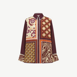 The Wilson Shirt is a versatile, relaxed-fit button-down featuring a patchwork of paisley, geometric, and zebra-print panels in shades of maroon, orange, and cream.