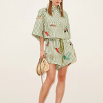 Model wearing KABE SHOP INC Bisou Short in green striped fabric with tropical print and a matching button-up shirt.
