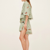 Model wearing KABE SHOP INC Bisou Short in green striped fabric with tropical print and relaxed jogger fit