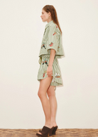 Model wearing KABE SHOP INC Bisou Short in green striped fabric with tropical print and relaxed jogger fit