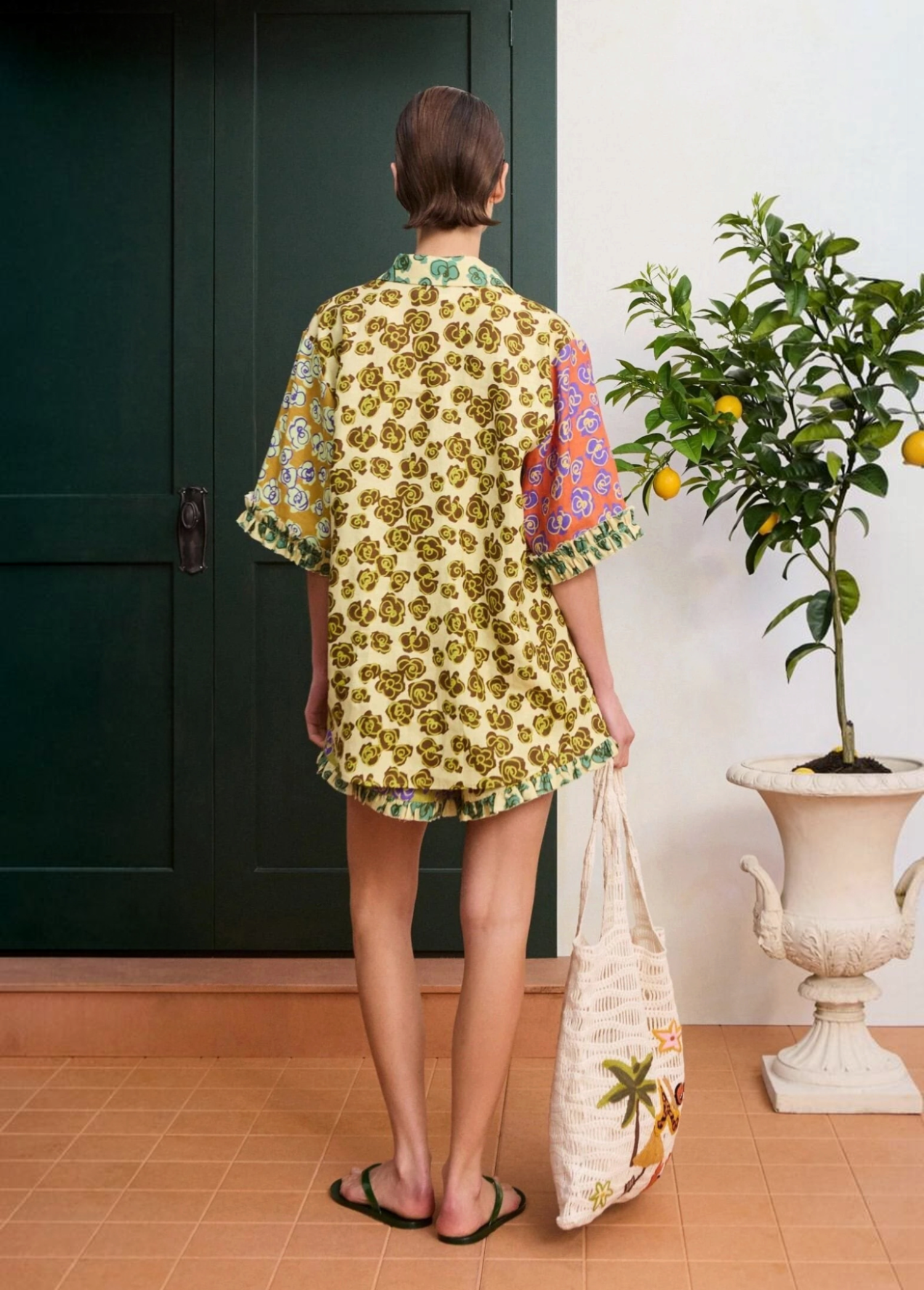KABE SHOP INC Patty Short worn with a matching floral print top and a woven tote bag in a casual summer setting