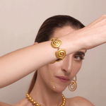 KABE SHOP INC Allinmi bracelet featuring gold spiral Tairona-inspired links worn on a model's wrist