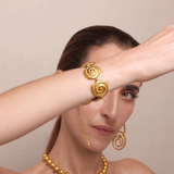 KABE SHOP INC Allinmi bracelet featuring gold spiral Tairona-inspired links worn on a model's wrist